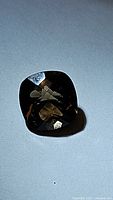 Close-up photo of single fancy cut smokey quartz gemstone showing cushion shape and checkerboard facets.