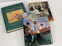 Three hardcover books laid flat on a white surface. Front covers visible showing titles and cover art. The books relate to Impressionist art and Ikebana flower arranging.
