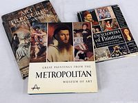 Three art books shown - 'Art Treasures of the World', 'Great Paintings from the Metropolitan Museum of Art', and 'Encyclopedia of Painting'