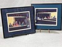 Two matching framed prints titled Jazz 1 and Jazz 2 by Hulus Mavruk, showing jazz club scenes with groups of people.