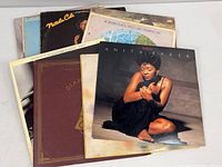 Photo showing 8 albums stacked with visible front covers including Anita Baker, Natalie Cole, Deniece Williams, Labelle, and Diana Ross.