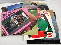 12 vintage vinyl album covers featured with well-known soul and pop artists. Covers show signs of wear but vinyl discs appear clean.