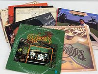 Photo of vinyl albums stacked together showing Commodores, Crusaders, Isley Brothers, John Kasandra, and Teddy Pendergrass.