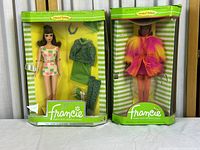 Two Francie Barbie dolls in original packaging showing front view with aging and damage to boxes.