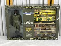 Front view of the boxed GI Joe U.S. Infantry action figure with military uniform and accessories visible through packaging