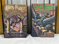 Front covers of both Harry Potter books showing the detailed illustrated dust jackets with title and author name.