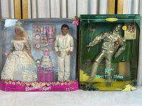 Full view showing Barbie and Ken Wedding Fantasy dolls set with accessories beside Ken as The Tin Man from Wizard of Oz boxed doll.