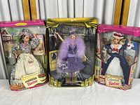 Three boxed Barbie dolls: Pioneer Barbie, Dance Till Dawn Barbie, and Colonial Barbie, displayed side by side.