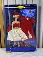Front view of the 1962 Silken Flame Barbie doll in original blue packaging with visible box corner damage.