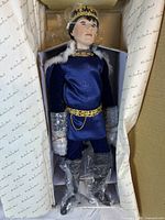 Prince Charming doll in original box with protective plastic wrapping on arms and boots, showing detailed costume and face