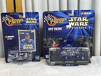 Two unopened packaged NASCAR Star Wars themed Jeff Gordon 1:64 scale die-cast models including one with pit crew diorama