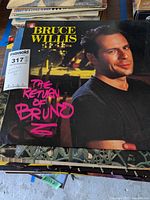 Photo of 'Bruce Willis - The Return of Bruno' album cover showing Bruce Willis portrait.