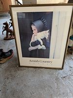 Framed Amherst Country print titled 'Sarah' featuring a young Amish girl holding a cat.
