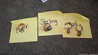 Photo showing the three items labeled Copper, Sterling, and .925 with earrings
