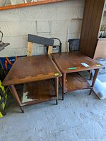 Pair of vintage Lane mid-century modern wooden end tables positioned side by side, showing overall condition and construction style.