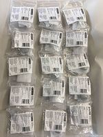 Lot of 15 individually packaged Amerock cabinet knobs in matte black, each with mounting hardware