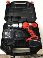 Black & Decker cordless drill kit including drill, battery charger, and battery in an open black plastic carrying case.