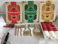 Set of Gator sandpaper sheets in 120, 80, and 220 grit, paint brushes in various sizes, small paint roller with handle, and roller refills.