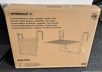 Box packaging showing product model 669759, Interbuild branding, and folded balcony table illustration with multiple languages.