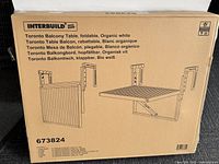 Box packaging showing the Interbuild brand and model 673824, product name Toronto Balcony Table with foldable design in organic white color.