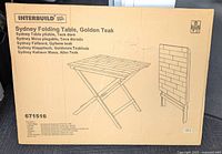 Box showing Interbuild Sydney Folding Table in Golden Teak, model 671516 with foldable design illustration.