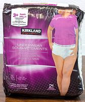 Front view of the packaged Kirkland Signature women's underwear size XL, showing product benefits, count, and purple branding.