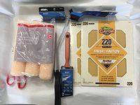 Lot contents showing Gator sandpaper sheets, paint rollers, and various brushes.