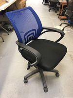 Front angle view of office chair showing blue mesh backrest and black seat with armrests and wheeled base.