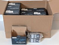 Box containing multiple black ink cartridge packs labeled OfficeWorld 902XL compatible with HP printers.
