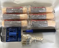 Photo showing six 9-inch paint roller refills, paint roller extension pole with foam handle, Pro-Edge edging tool, and four paint brushes.