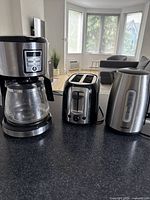 Full view of the Black and Decker coffee maker, Black and Decker toaster, and Comfee kettle on kitchen counter