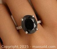 Ring worn on finger to show scale and fit