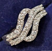 Close-up image of the sterling silver ring showing the triple wave design with multiple cubic zirconia stones.