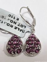 Pair of sterling silver garnet cluster teardrop earrings with lever-back clasps and sale tag attached, shown close-up for detail