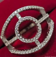 Close-up angled view of the sterling silver CZ ring showing the round open center and two concentric circles with the CZ stones detailed on the band.