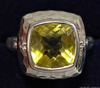 Close-up front view of silver ring featuring a bright yellow faceted square quartz gemstone set in a polished silver bezel with small silver bead accents.