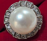 Front close-up showing large round white freshwater pearl surrounded by alternating square and baguette cubic zirconias.