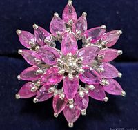 Close-up image of the top view of the silver ring with multiple marquise ruby stones arranged in a floral cluster design.