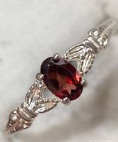 Close-up of the garnet stone and detailed band design.