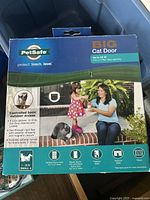 Photo of PetSafe Big Cat Door packaging showing product features, pet weight limit, and flap size.