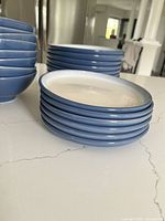 Stack of blue bowls with white interiors