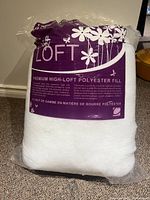Front view of the Soft Loft polyester fill bag showing the brand label, product type, and flower graphics.