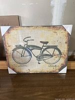Front view of the vintage bicycle canvas art with white corner protectors.