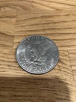 Photo of one Eisenhower silver dollar coin dated 1972, showing reverse side with eagle and inscriptions