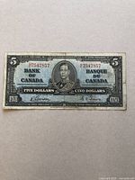 Front view of the 1937 Series $5 Canadian bank note featuring King George VI portrait with serial number and bilingual denomination text.