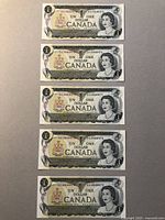 Five sequential Canadian $1 bank notes from 1954 series displayed face up.