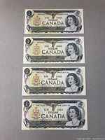 Top view of 4 sequential Canadian $1 bank notes laid flat showing front design with Queen Elizabeth II and Canadian coat of arms.