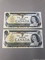 Two Canadian $1 bank notes placed one above the other showing front face with Queen Elizabeth II portrait and serial numbers.
