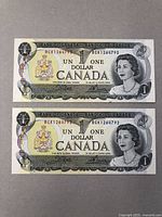 Two sequential $1 Canadian banknotes placed side by side, showing front of each note with clear portraits and serial numbers.