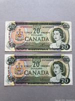 Front side of two Canadian $20 bank notes from 1969 Series showing Queen Elizabeth II portrait and multicolor design with serial numbers.